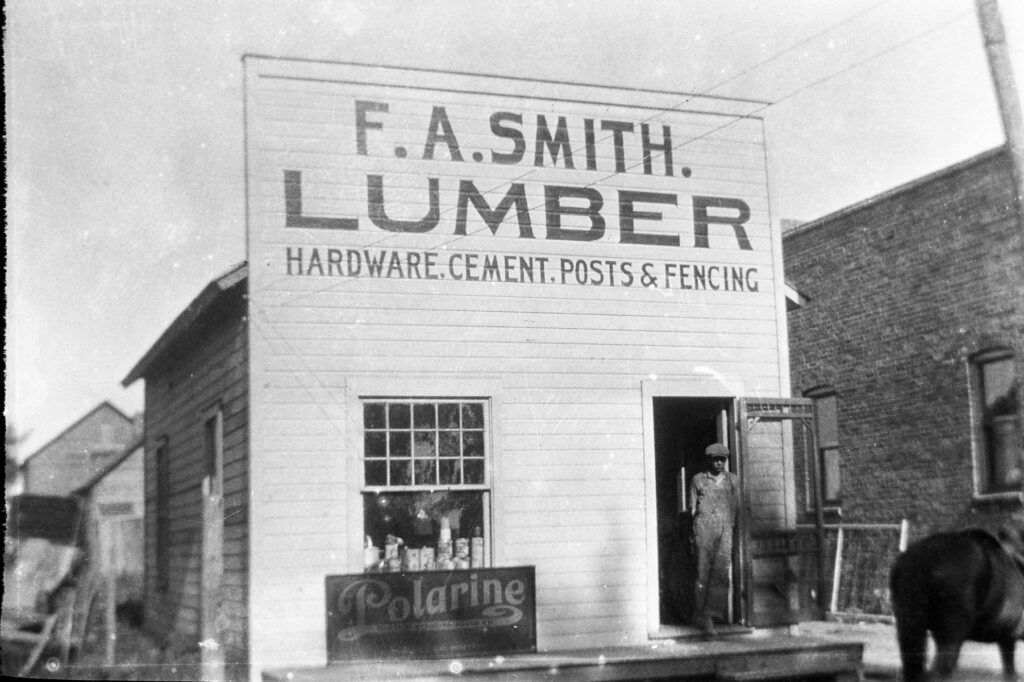 F. A. Smith lumber store. Store front signage reads "F. A. Smith. Lumber. Hardware, cement, posts & fencing"